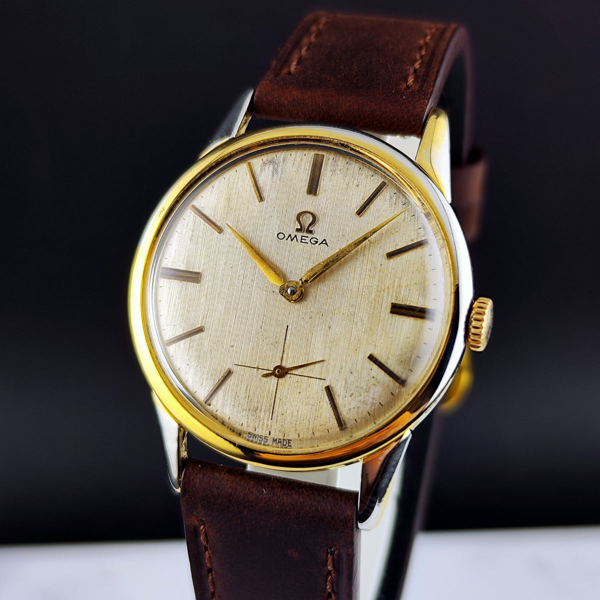 Omega Classic Gold White Dial 1960 – Schrägansicht mit Lederband und Krone