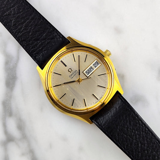 Omega Gold Quartz Champagne Dial German DayDate Defective Fullset – Vorderansicht Zifferblatt mit Datumsanzeige